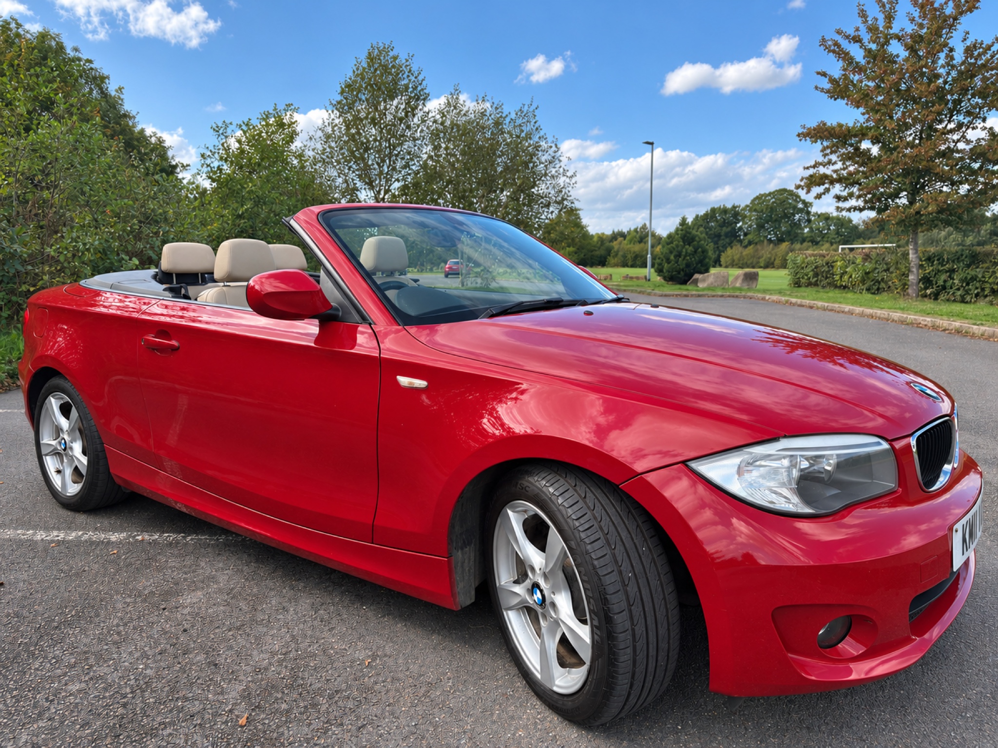 Red BMW 118i Sport convertible with the roof down